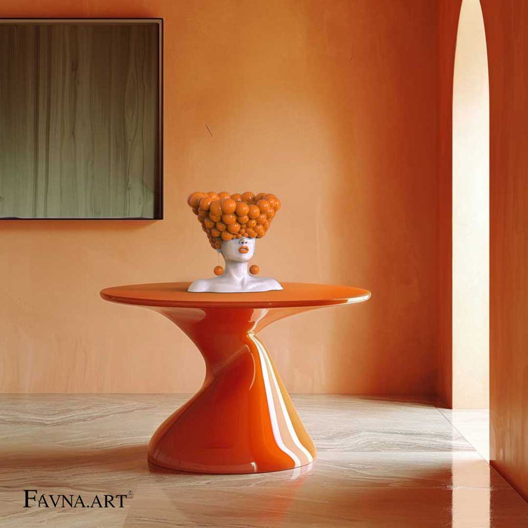 An orange head sculpture stay on a table in a modern interior with orange and green hues. arancioni e verdi.