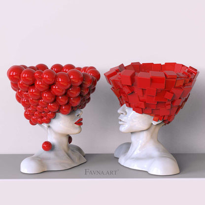 Philosophical art pieces of man and woman white bust with vibrant red globes and bricks, lips and earrings named "Thought" by Italian brand "Favna.Art"