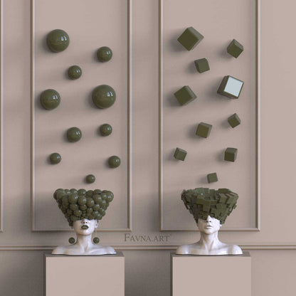 Male and female bust sculptures “Thoughts” by FAVNA.ART, featuring olive green spheres and cubes in a contemporary art composition.